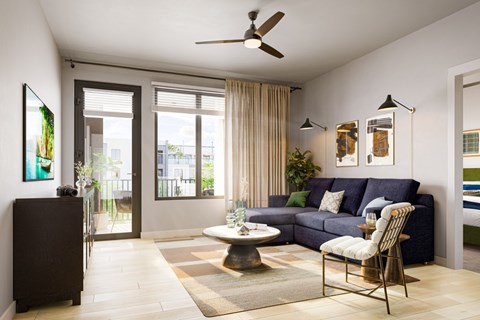 A living room with a dark blue couch and a white chair.