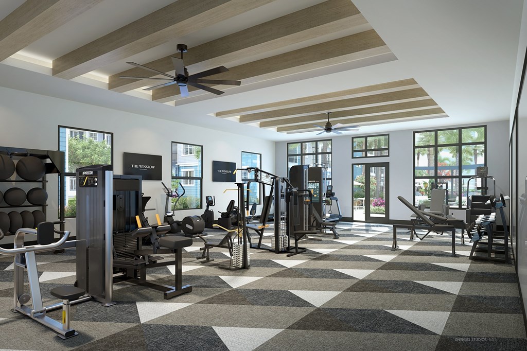 A gym with a variety of equipment including treadmills, weights, and exercise machines.