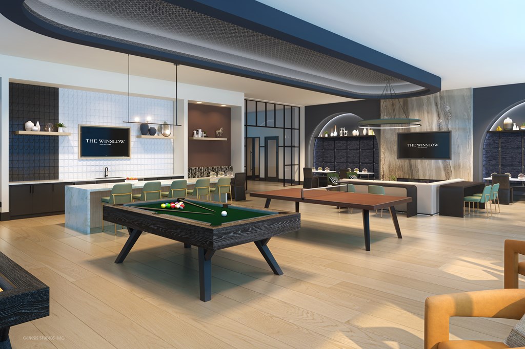 A billiard table is in the middle of a room with a bar area in the background.