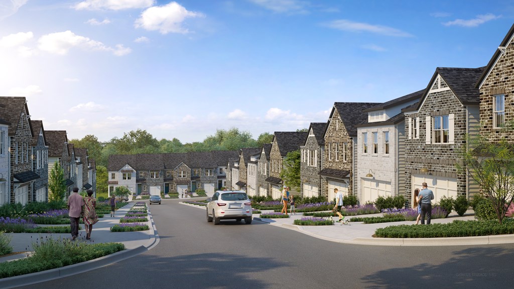 A street view of a residential area with houses on both sides and people walking on the sidewalks.