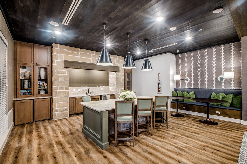 a kitchen with a large center island with a breakfast bar and a living room with a couch