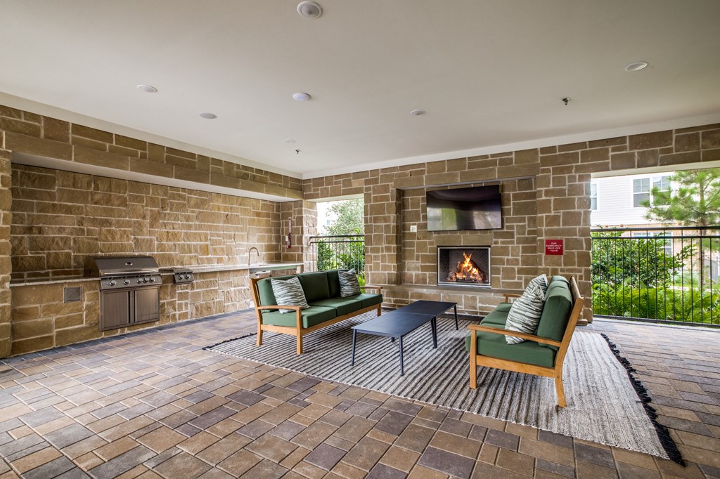 a resident clubhouse with a fire place and lounge chairs