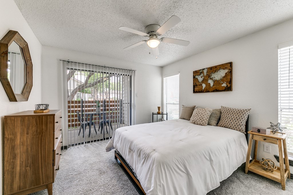 a bedroom with a bed and a ceiling fan