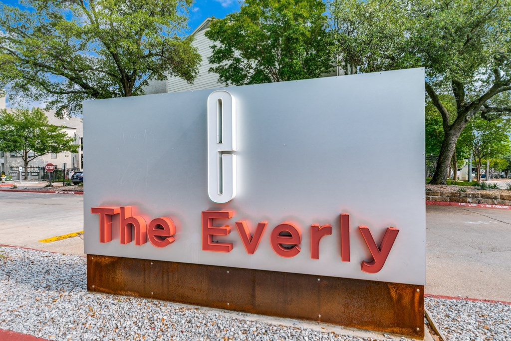 a sign for the everly on the side of a street