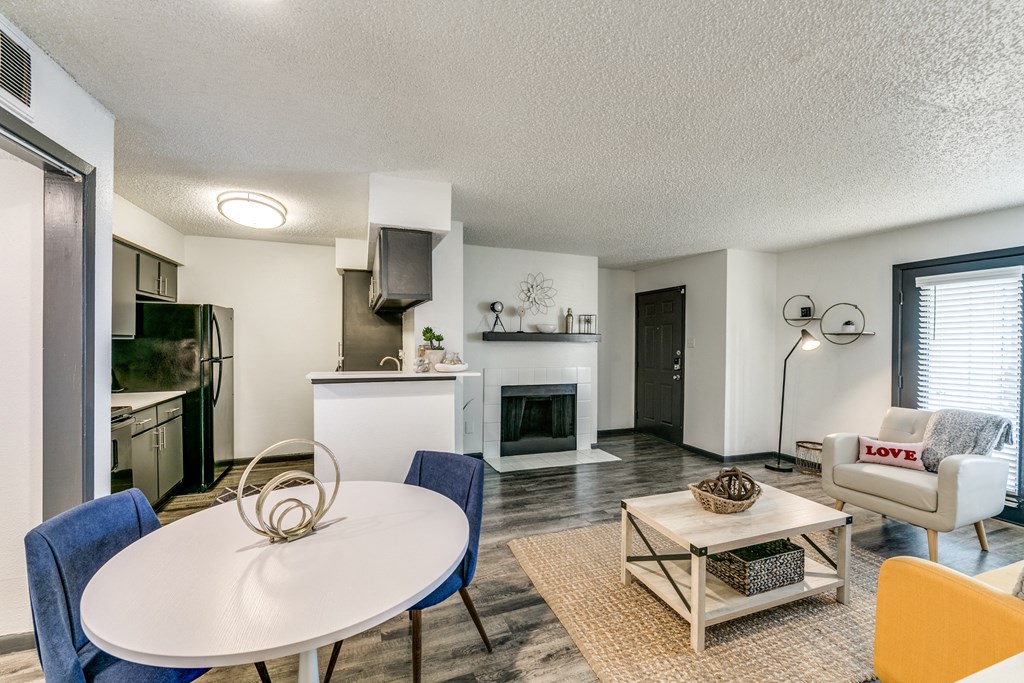 an open living room and kitchen with a table and chairs
