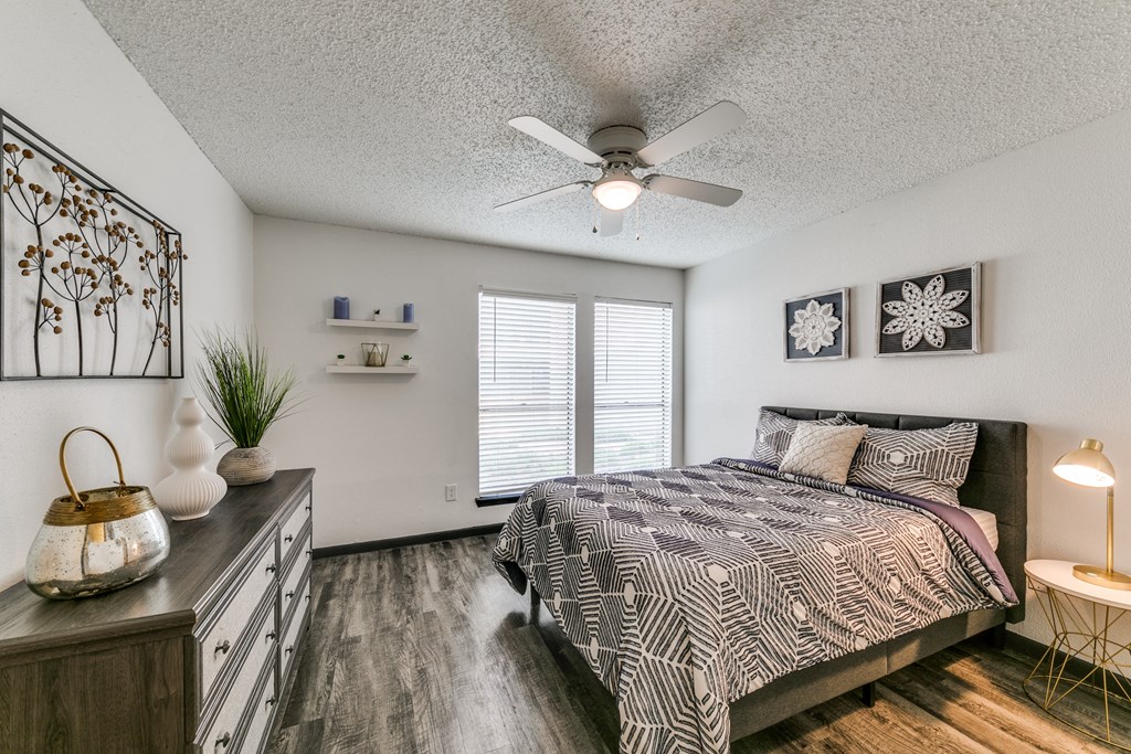 a bedroom with a bed and a ceiling fan