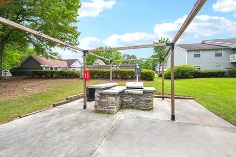 A playground with a swing set and a red flag.