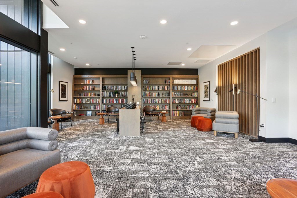 A library with a carpeted floor and bookshelves filled with books.