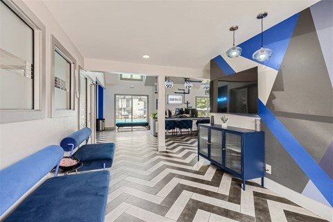 a lobby with blue couches and a tv