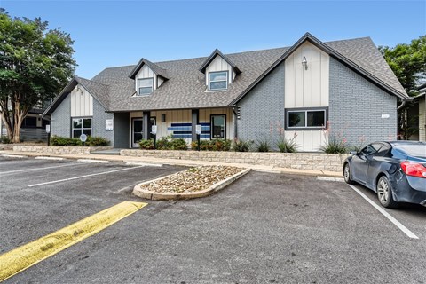 a house with a parking lot and a car in front of it