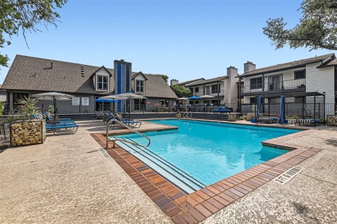 our apartments have a swimming pool and a patio with chairs