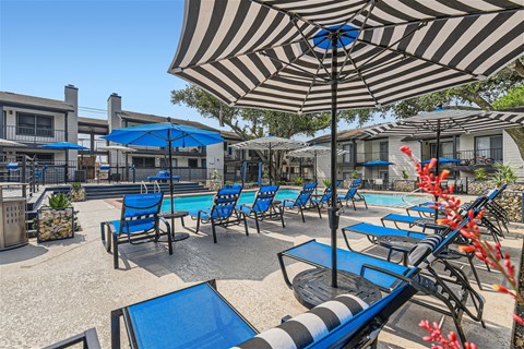 our patio is full of chairs and umbrellas and a pool