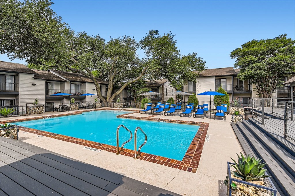 our apartments have a swimming pool with chairs and umbrellas