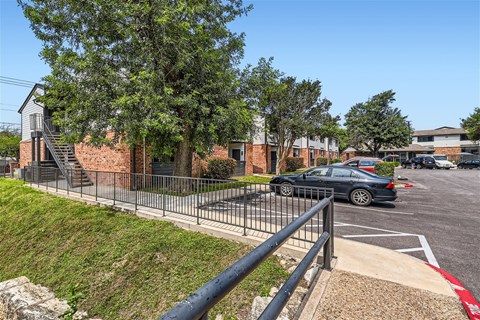 a car parked in a parking lot in front of a building