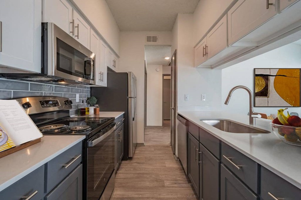 a kitchen with stainless steel appliances and a sink