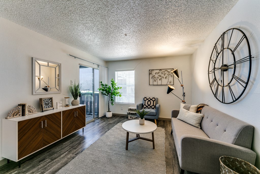 a living room with a couch and a clock on the wall