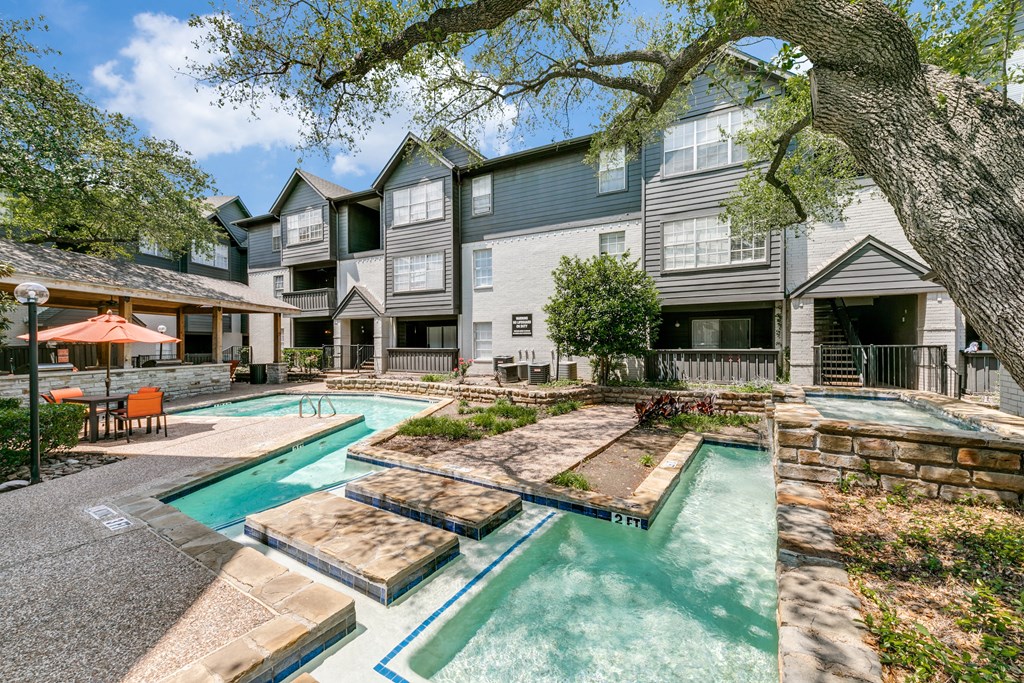 our apartments have a swimming pool and a courtyard with trees