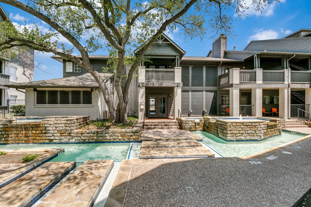 a house with a swimming pool and a tree in front of it