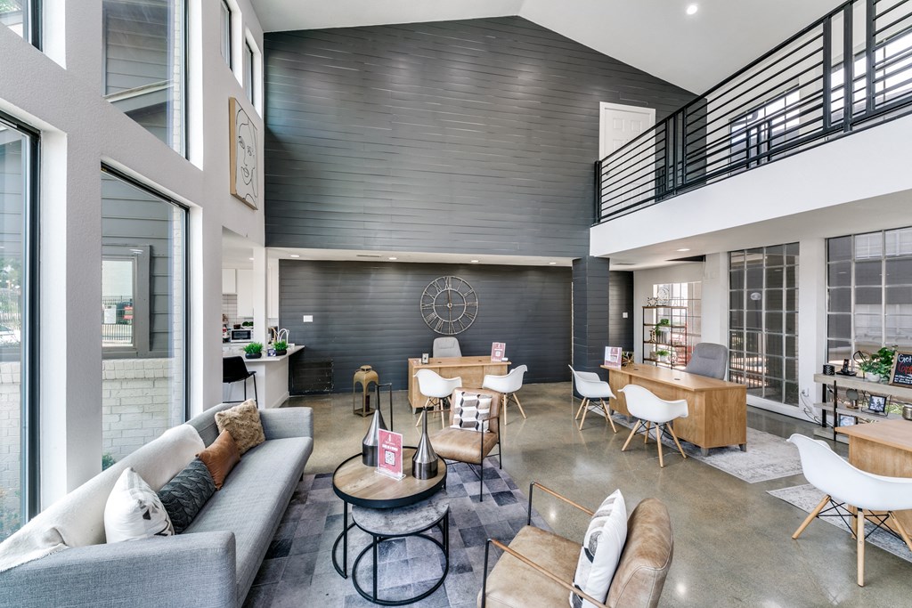 an open living room with couches and chairs and a dining room table