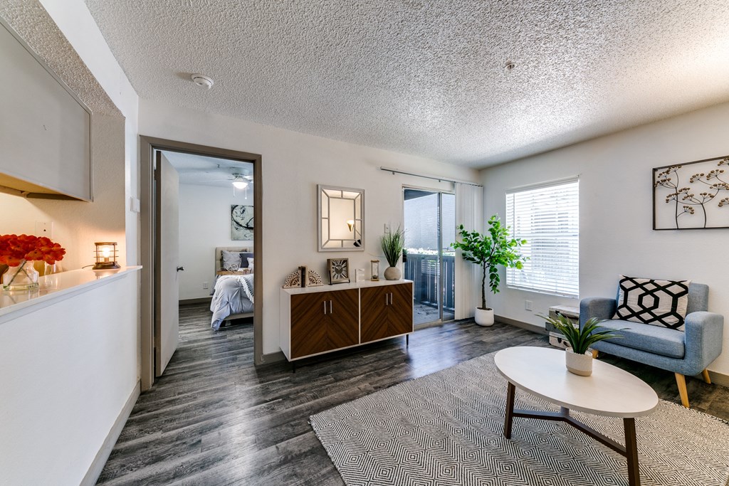a living room with a couch and a table     and a bedroom