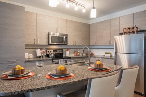 a kitchen with a granite counter top with plates of food on it