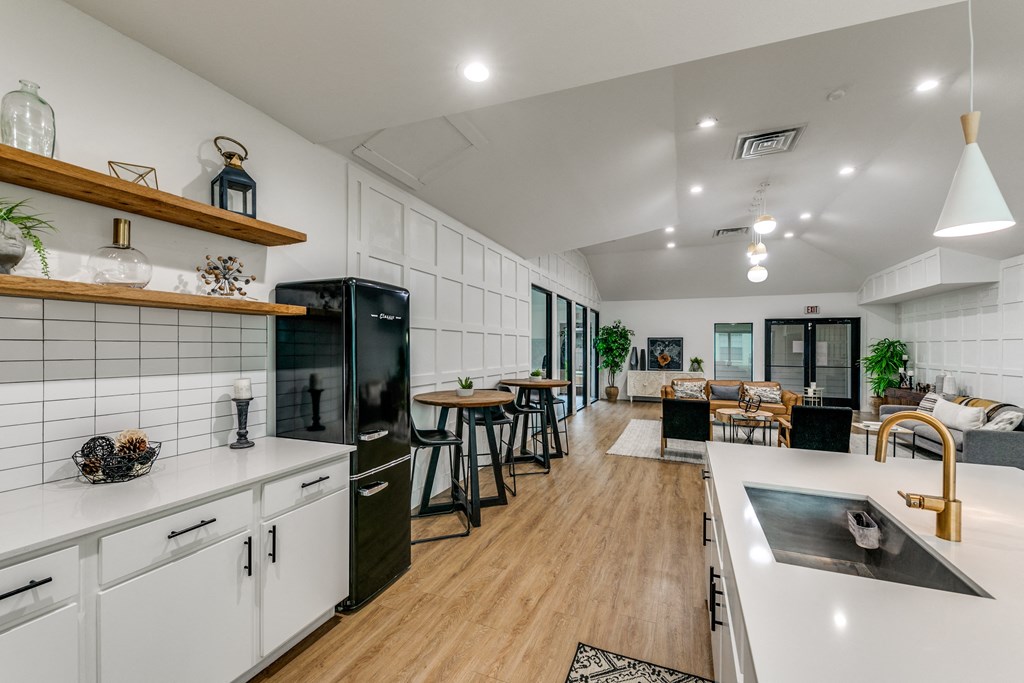 an open kitchen and living room with a dining area and a kitchen counter with a