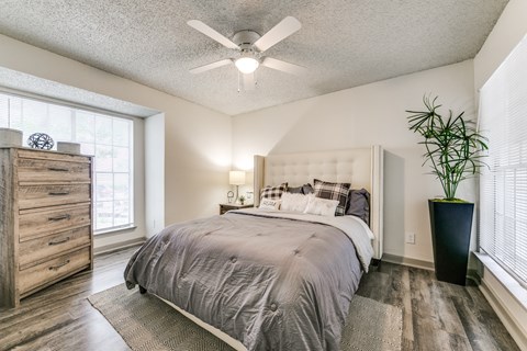 a bedroom with a bed and a ceiling fan