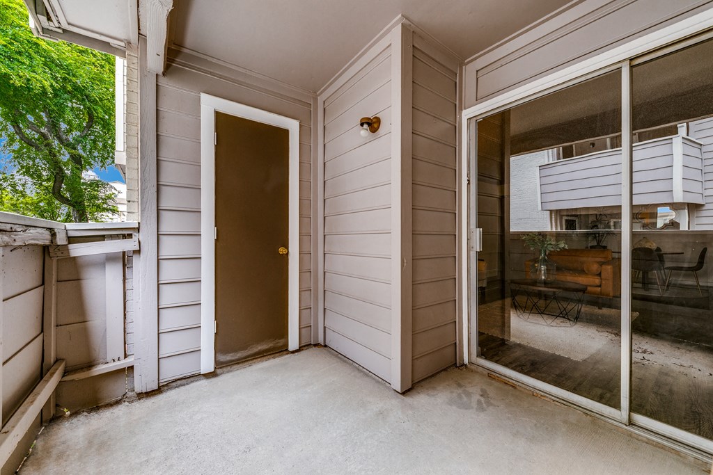 the entrance to a home with a patio and a door to the yard