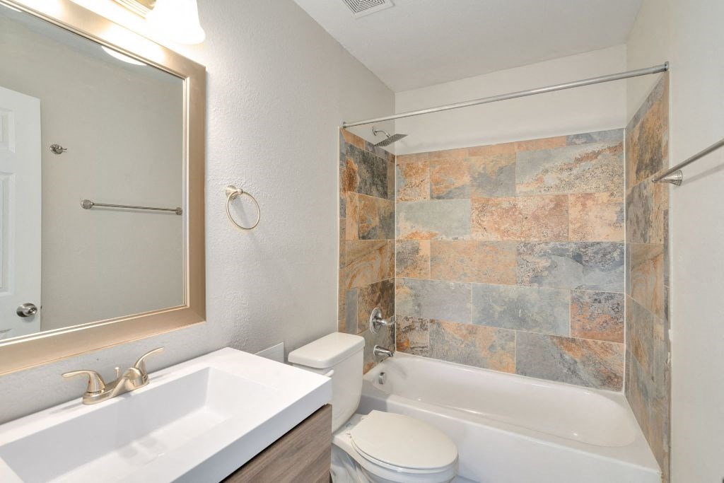 a bathroom with a sink toilet and a shower