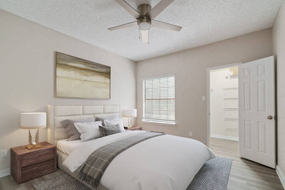 a bedroom with a bed and a ceiling fan