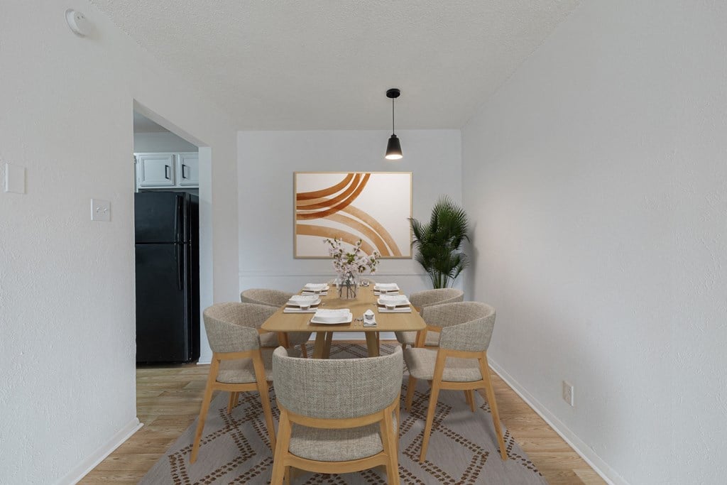an image of a dining room with a table and chairs
