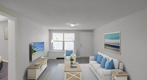 a living room with a white couch and a television