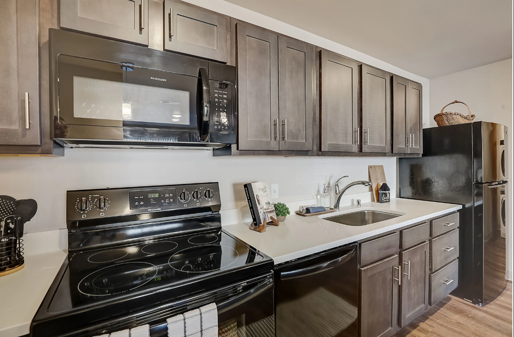 a kitchen with stainless steel appliances and black appliances