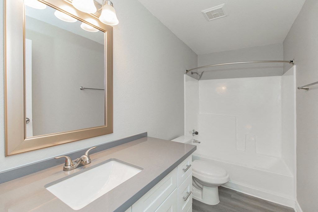 a bathroom with a toilet sink and bathtub