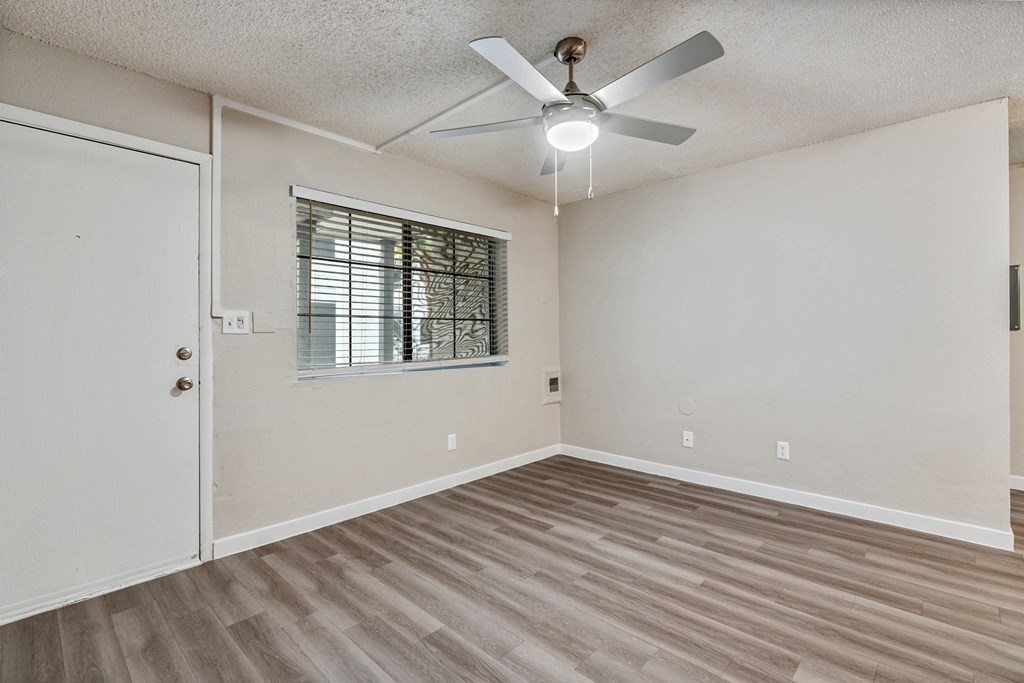 a bedroom with hardwood floors and a ceiling fan
