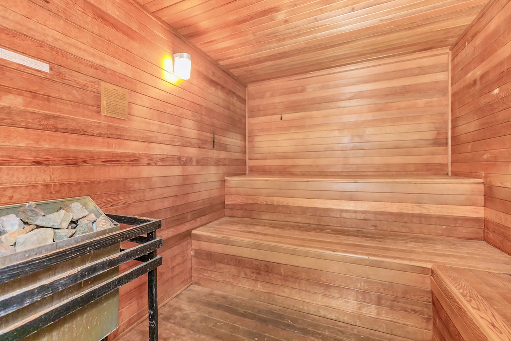 a wooden sauna with a bench and a table