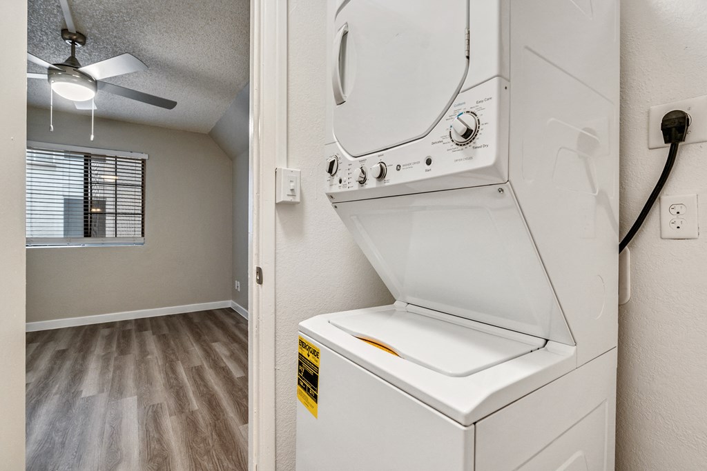 a washer and dryer in a room with a ceiling fan