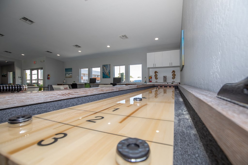a bowling alley with wood lanes and numbers on the floor