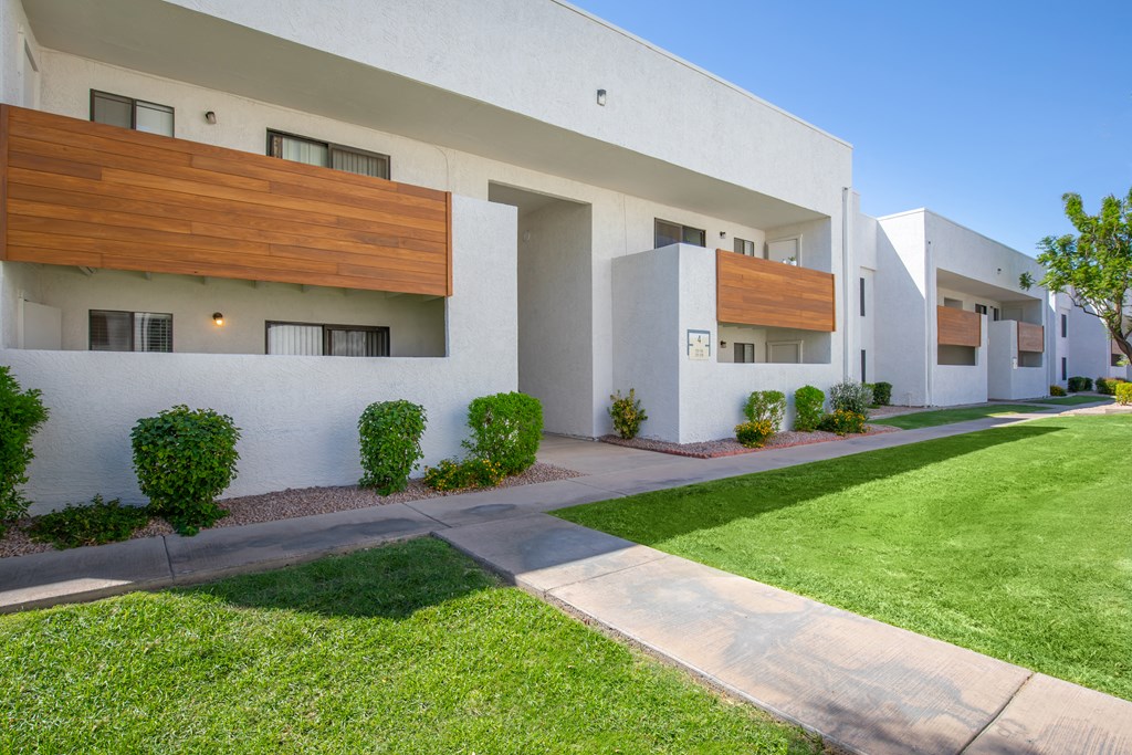 a white building with a green lawn in front of it