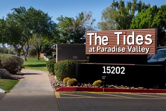 a sign for the tides at paradise valley