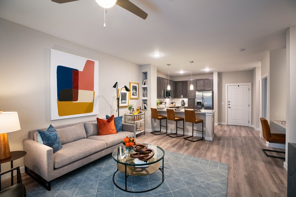 living room view with kitchen and barstools