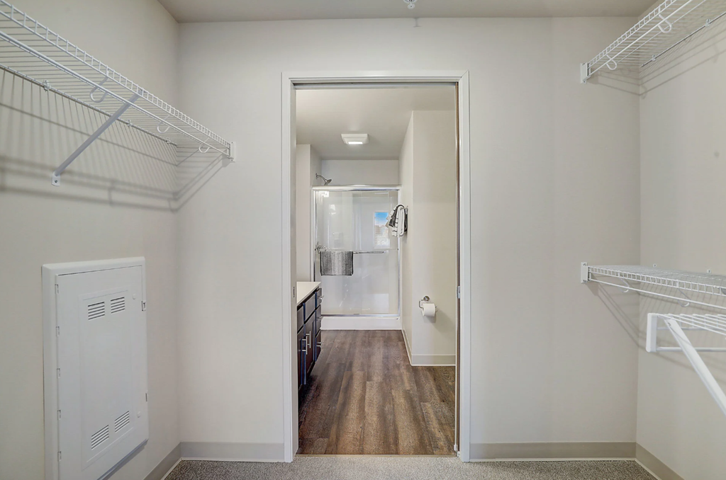 a bedroom with a closet and a door to a bathroom