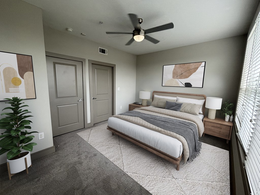 a bedroom with a bed and a ceiling fan