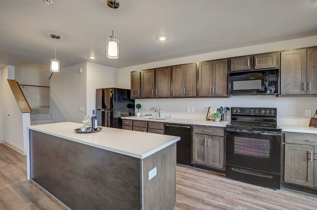 a kitchen with wooden cabinets and a white counter top