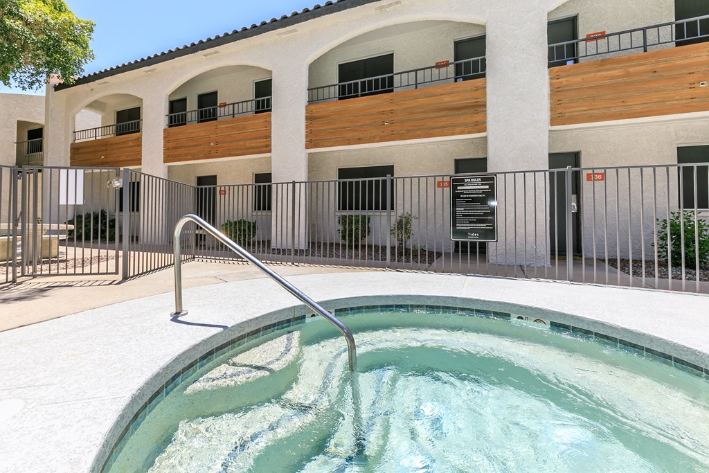 a hot tub in a pool in front of a building