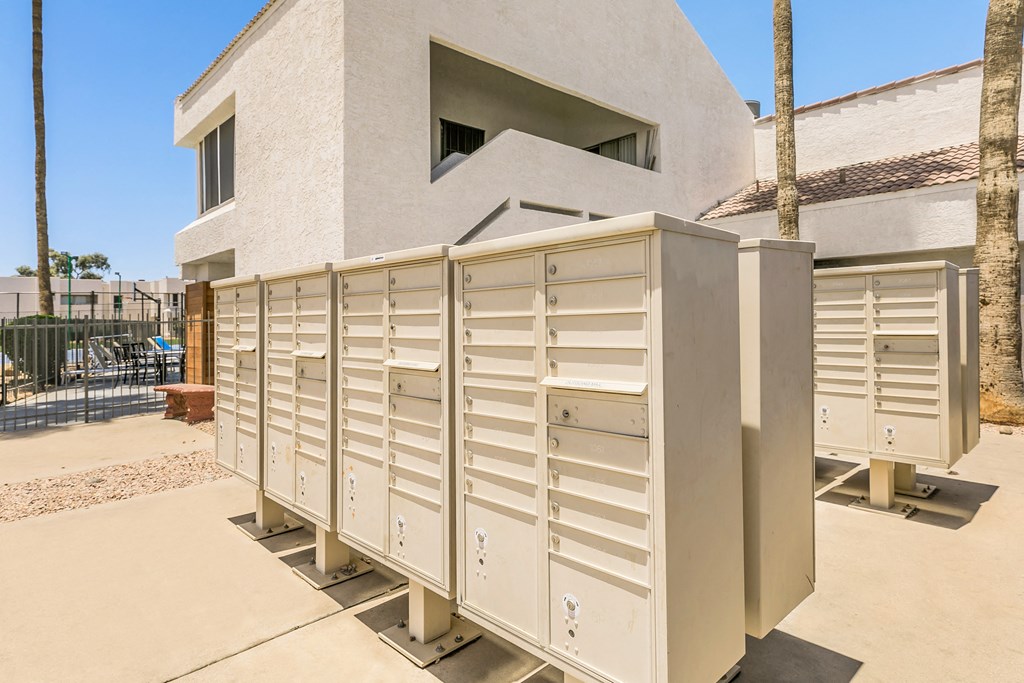 a row of mailboxes in front of a house