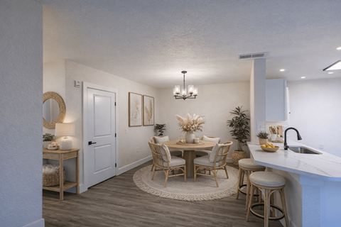 A dining area with a round table and chairs.