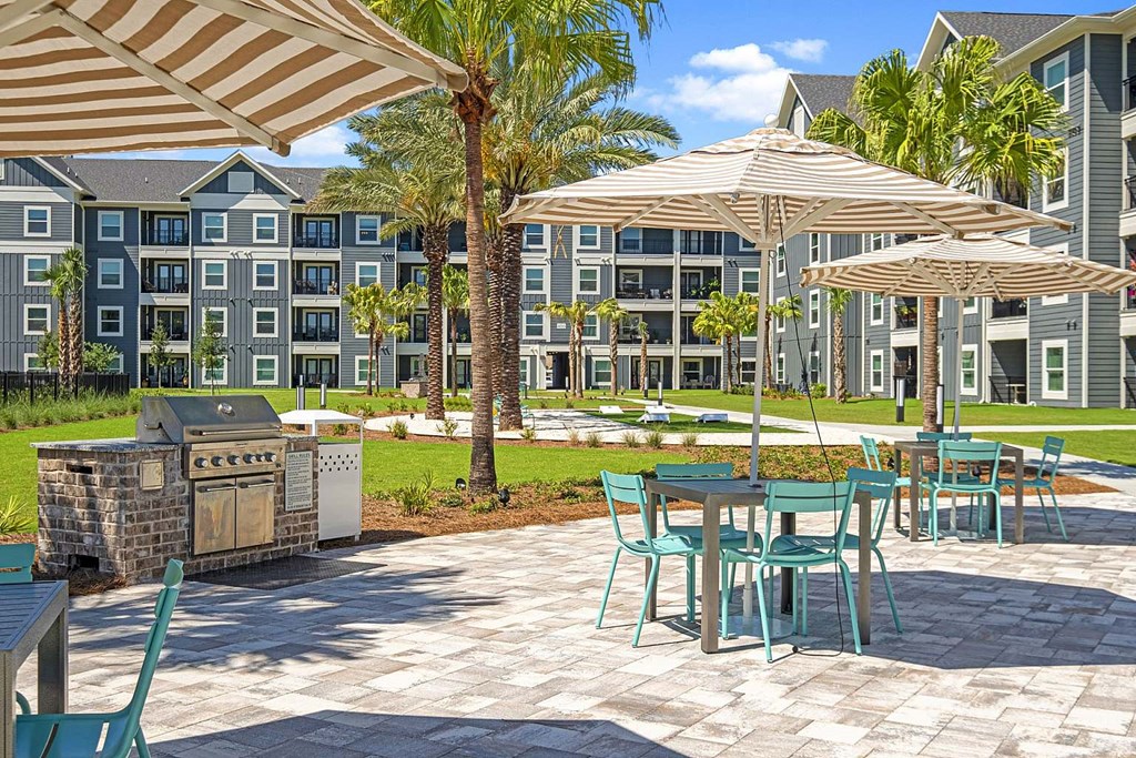 an outdoor patio with tables and chairs and umbrellas