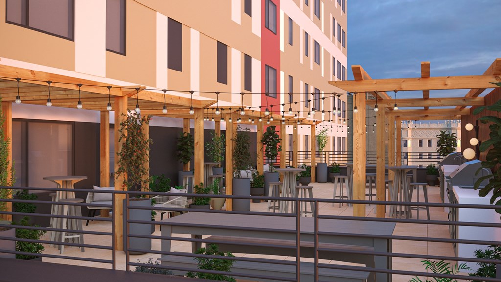 A modern outdoor seating area with wooden pergolas and tables.