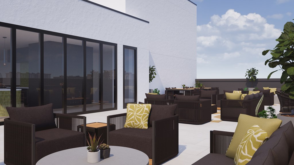 A patio with brown furniture and a white table.